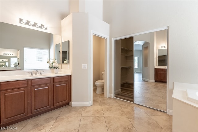 bathroom featuring tile patterned floors, vanity, and toilet