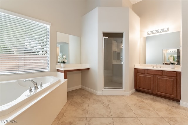 bathroom with tile patterned floors, vanity, and independent shower and bath