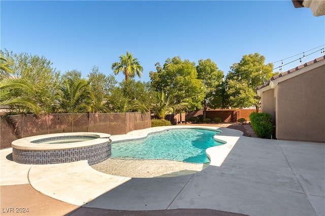 view of swimming pool with an in ground hot tub and a patio area