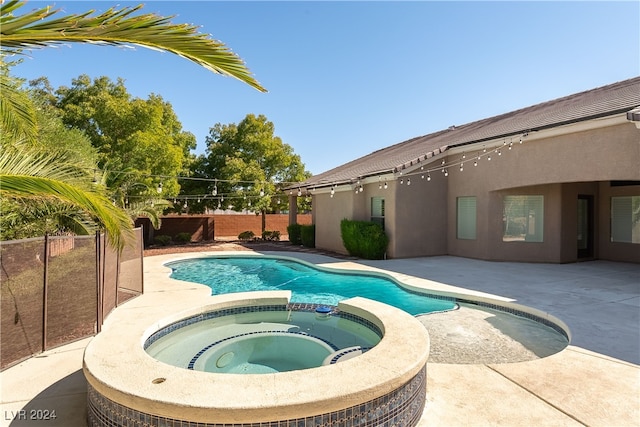 view of swimming pool with an in ground hot tub and a patio area