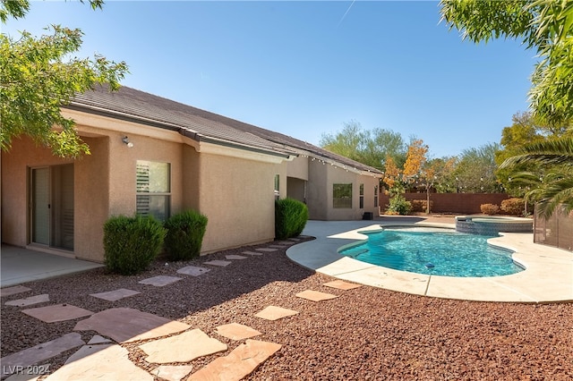 view of pool featuring an in ground hot tub and a patio