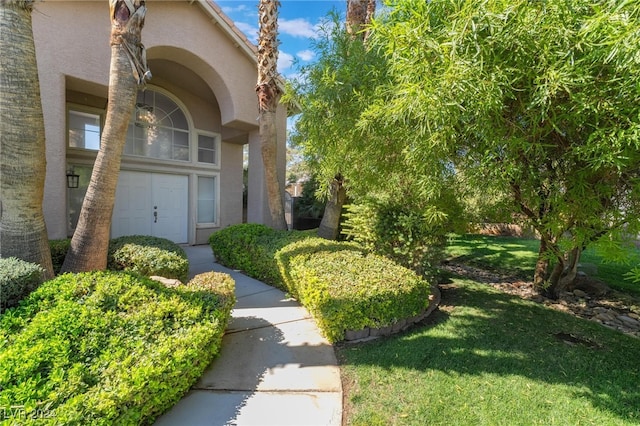 property entrance with a lawn