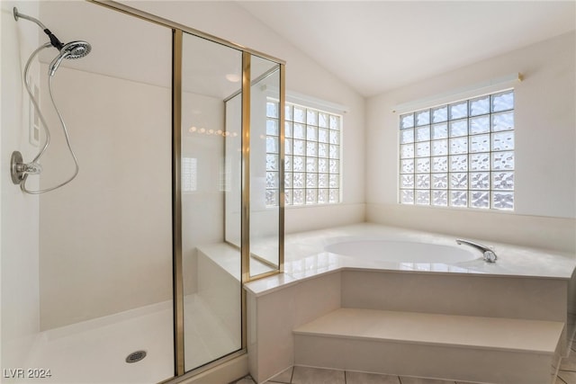 bathroom with lofted ceiling, tile patterned flooring, and plus walk in shower