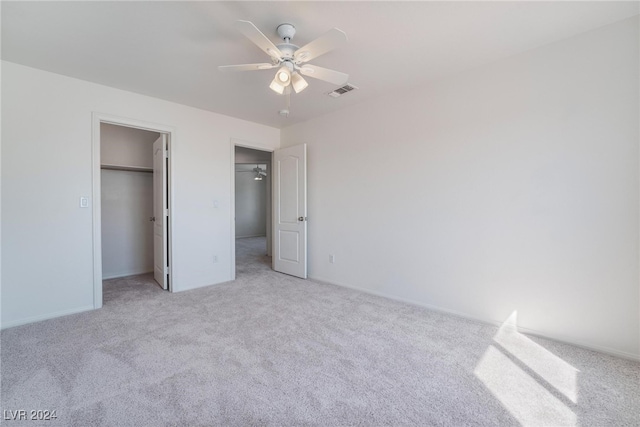 unfurnished bedroom with light colored carpet and ceiling fan