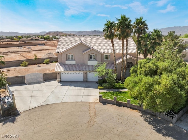 view of front of home with a garage and a mountain view