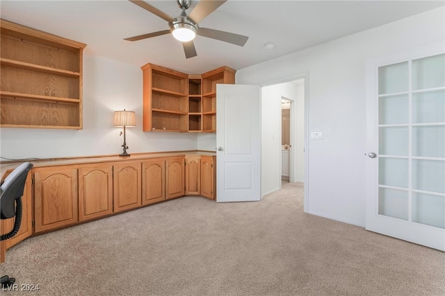 unfurnished office featuring light colored carpet and ceiling fan