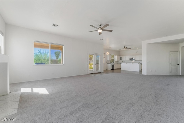 unfurnished living room with light tile patterned floors and ceiling fan