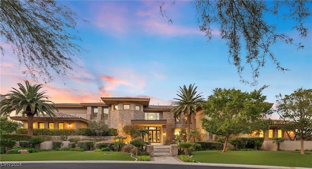 mediterranean / spanish-style home featuring a lawn