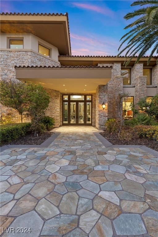 back house at dusk with french doors