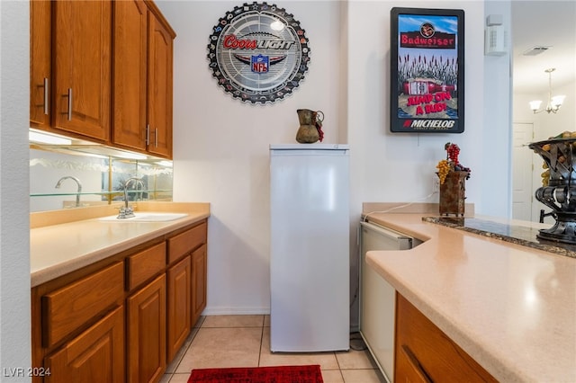 kitchen with light tile patterned flooring, an inviting chandelier, sink, decorative backsplash, and white fridge