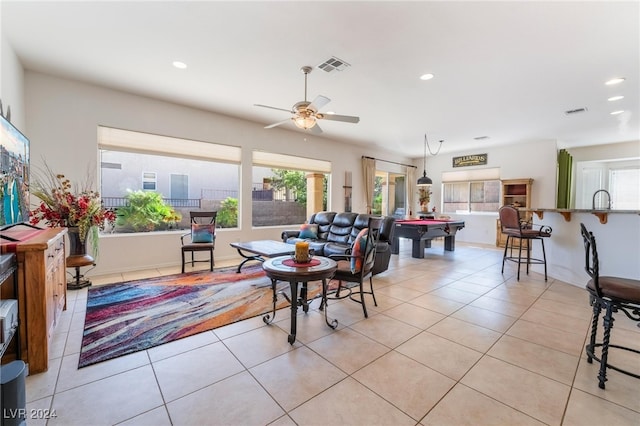 living room featuring ceiling fan, pool table, and light tile patterned floors