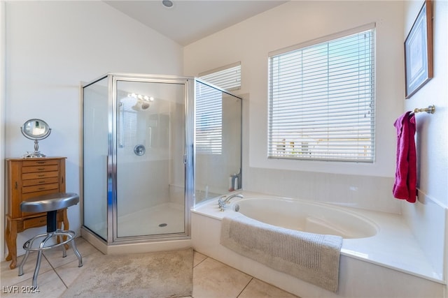 bathroom with tile patterned flooring, shower with separate bathtub, and lofted ceiling