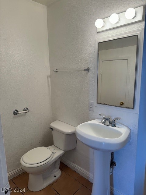 bathroom with tile patterned flooring and toilet