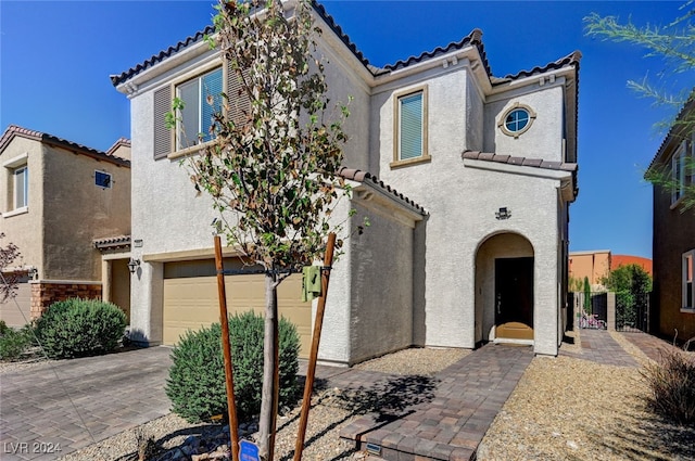 mediterranean / spanish-style home featuring a garage