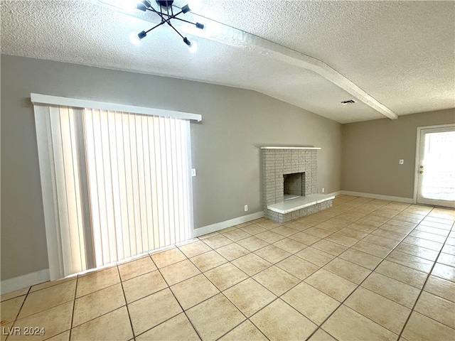 unfurnished living room with vaulted ceiling, a textured ceiling, a fireplace, and light tile patterned floors