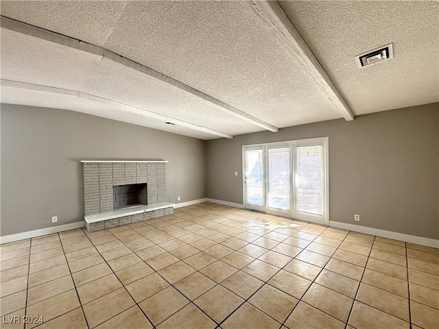 unfurnished living room with a fireplace, lofted ceiling with beams, light tile patterned floors, and a textured ceiling