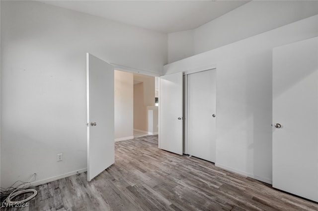 unfurnished bedroom featuring a closet and light hardwood / wood-style floors