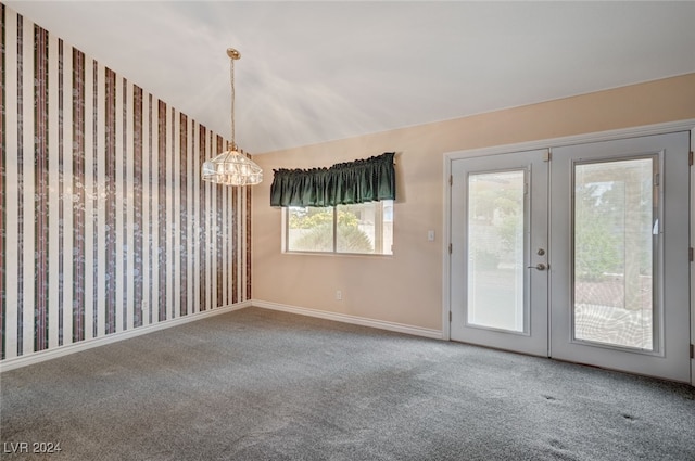 carpeted spare room featuring french doors