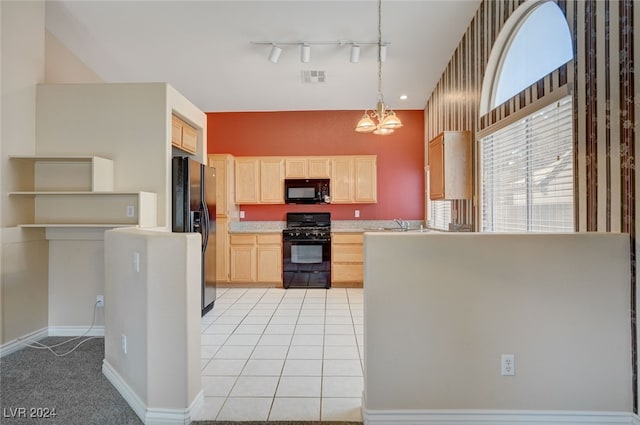 kitchen with black appliances, light brown cabinets, track lighting, decorative light fixtures, and light tile patterned floors