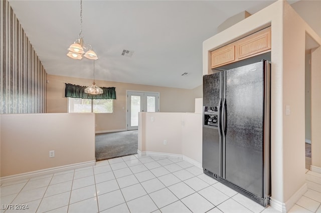 kitchen featuring black fridge, an inviting chandelier, light brown cabinets, and light tile patterned floors