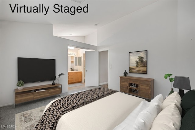 bedroom featuring lofted ceiling, ensuite bathroom, and carpet flooring