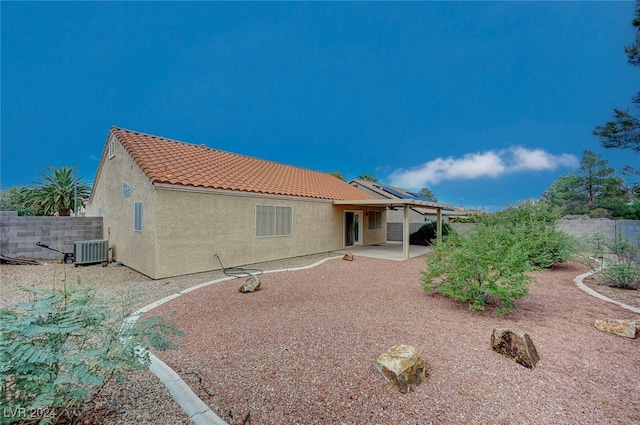 back of house with a patio area and central AC