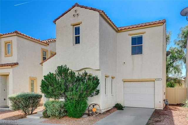 mediterranean / spanish-style home with a garage