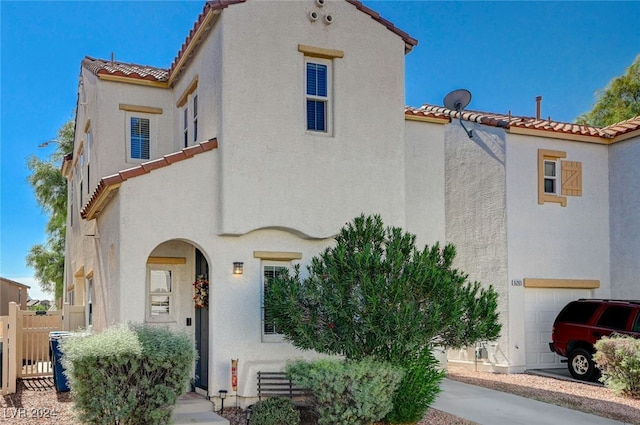 mediterranean / spanish-style house with a garage