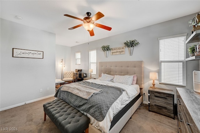 bedroom featuring baseboards, a ceiling fan, and light colored carpet