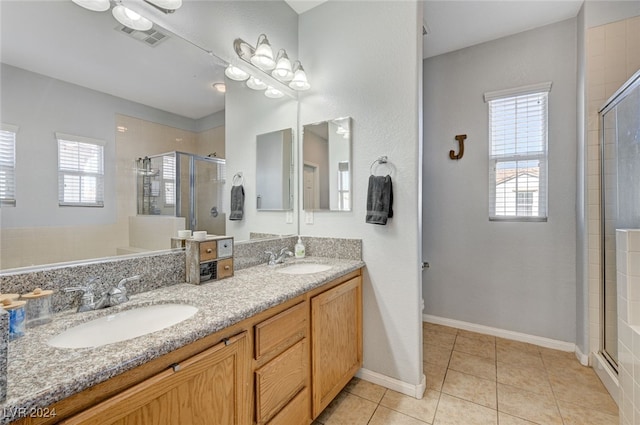 full bathroom with visible vents, a sink, a shower stall, and tile patterned floors