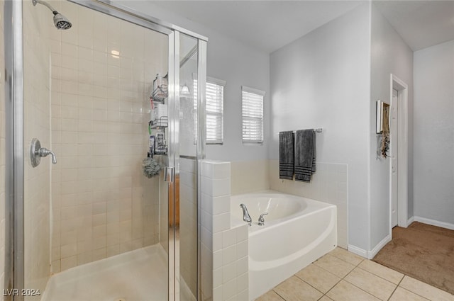 full bathroom featuring a stall shower, tile patterned flooring, baseboards, and a bath