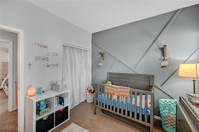 bedroom featuring a nursery area and carpet