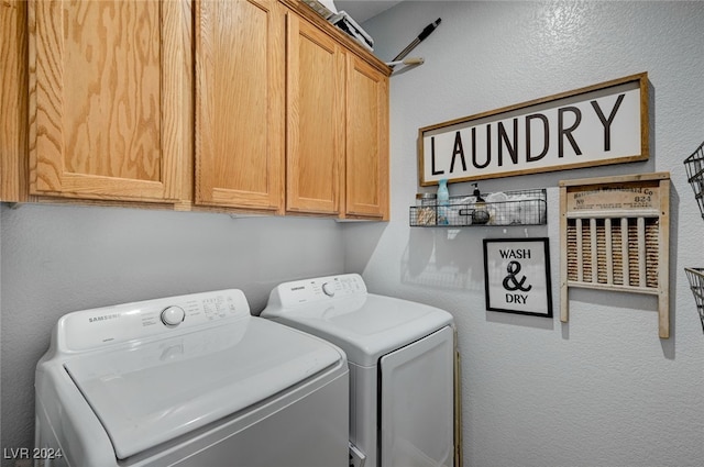 washroom featuring a textured wall, separate washer and dryer, and cabinet space