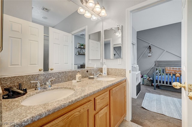 full bathroom featuring double vanity, visible vents, and a sink