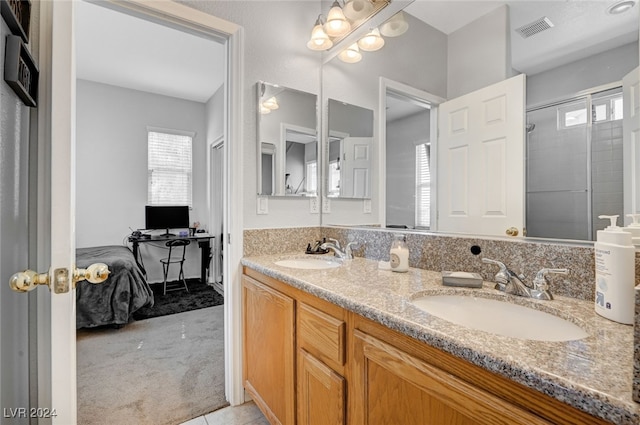 bathroom featuring connected bathroom, visible vents, a sink, and double vanity