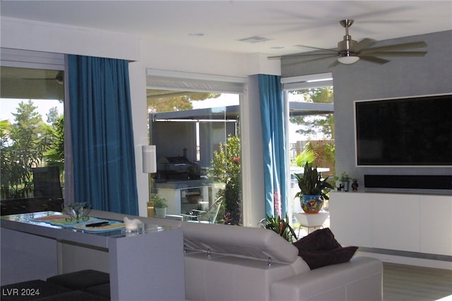 living room featuring hardwood / wood-style flooring and ceiling fan