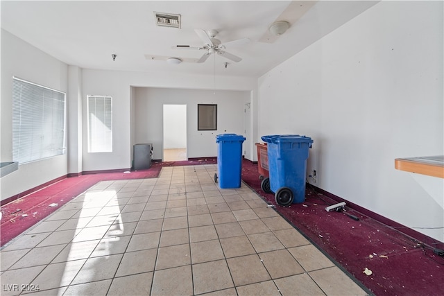 interior space with ceiling fan and light tile patterned floors