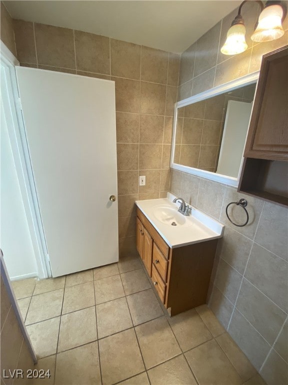 bathroom with tile patterned flooring, backsplash, vanity, and tile walls