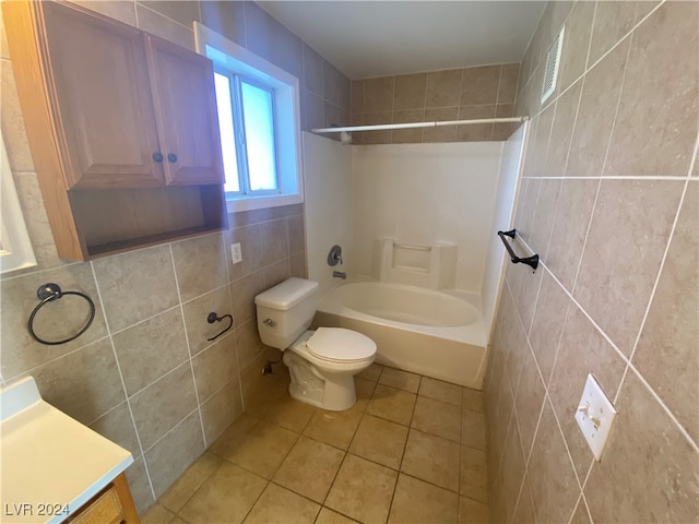 full bathroom with vanity, toilet, washtub / shower combination, tile walls, and tile patterned flooring