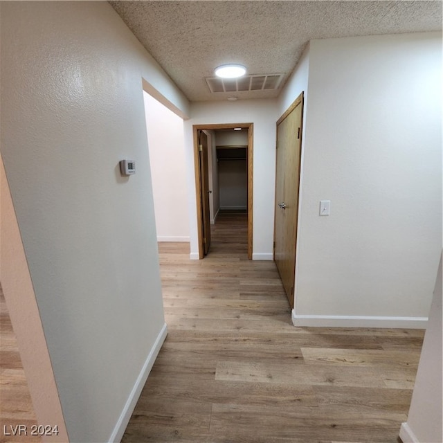 hallway with light hardwood / wood-style flooring