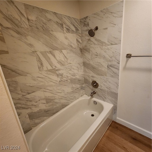 bathroom featuring hardwood / wood-style flooring and tiled shower / bath combo