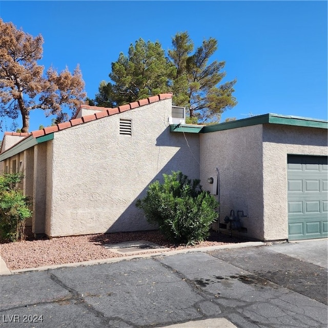 view of side of home featuring a garage