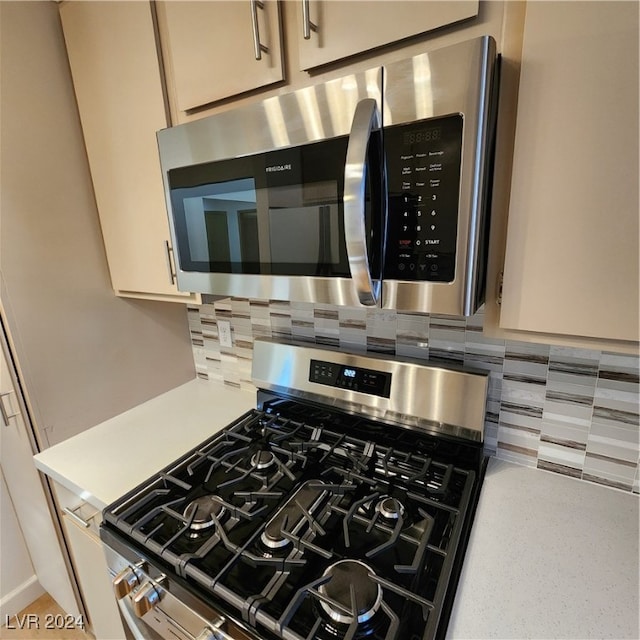 room details with stainless steel appliances and tasteful backsplash