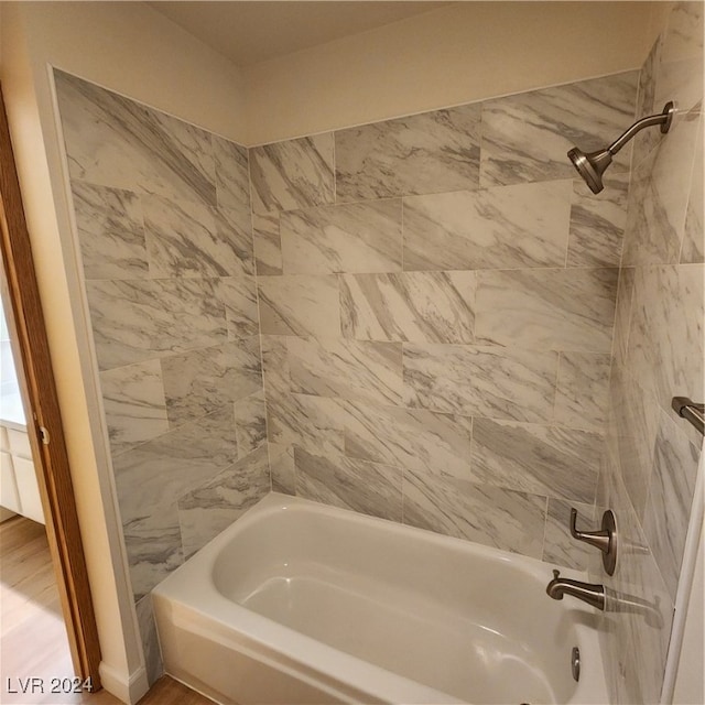 bathroom featuring hardwood / wood-style floors and tiled shower / bath combo