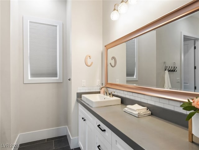 bathroom with tile patterned floors, vanity, and tasteful backsplash