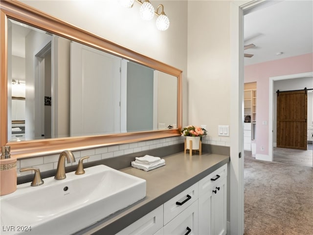 bathroom with vanity and tasteful backsplash