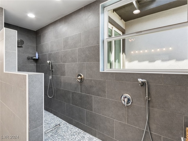 bathroom with tiled shower