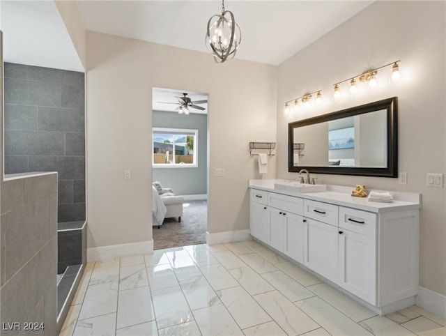 bathroom with ceiling fan with notable chandelier and vanity