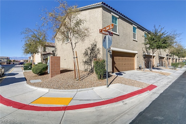 view of side of home featuring a garage