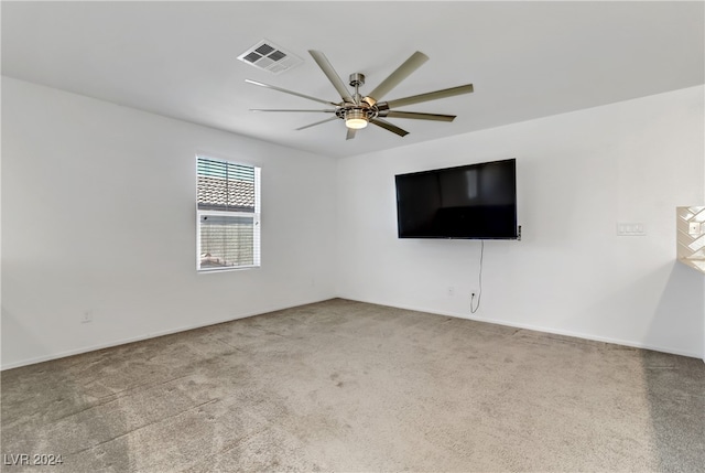 carpeted spare room with ceiling fan